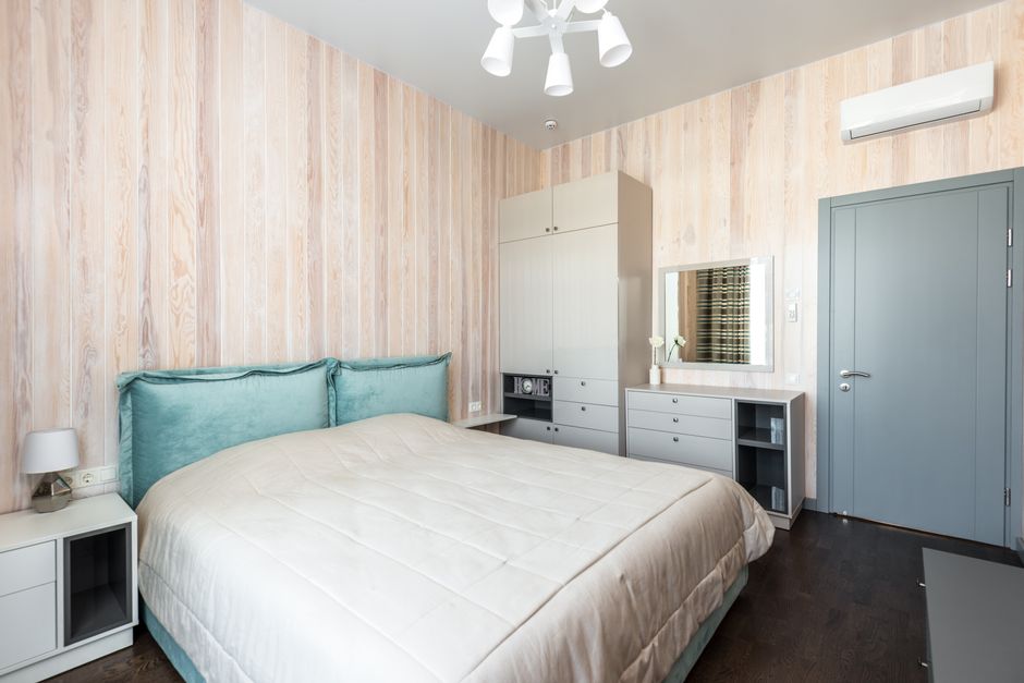 Bright and airy modern bedroom with sleek furniture and minimalist decor.
