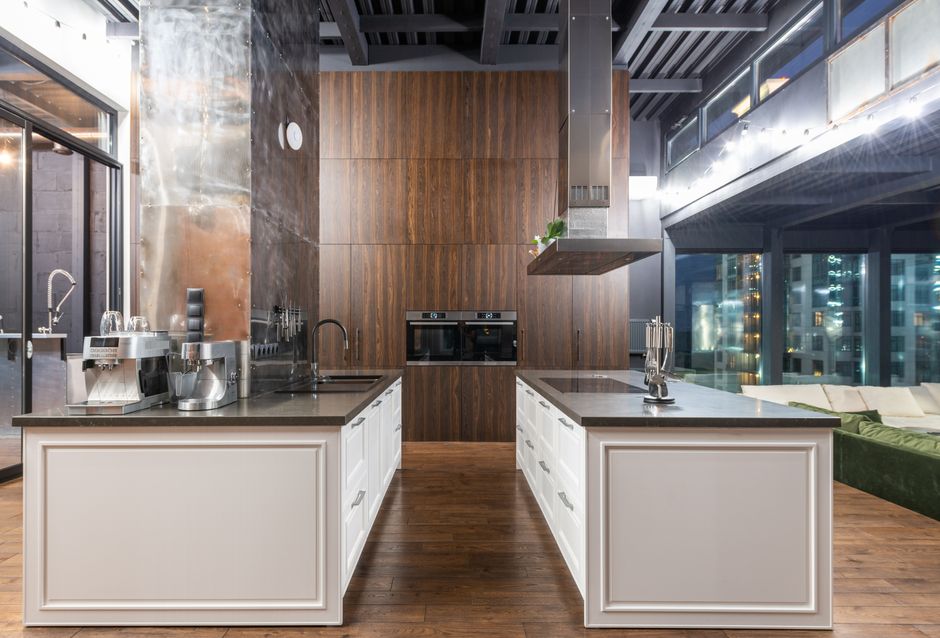 Interior of contemporary spacious kitchen with stylish furniture in apartment with loft style