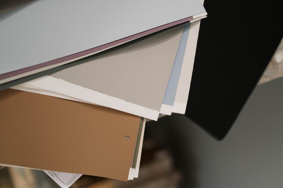 A close-up of assorted colored paper sheets, ideal for design and stationery projects.
