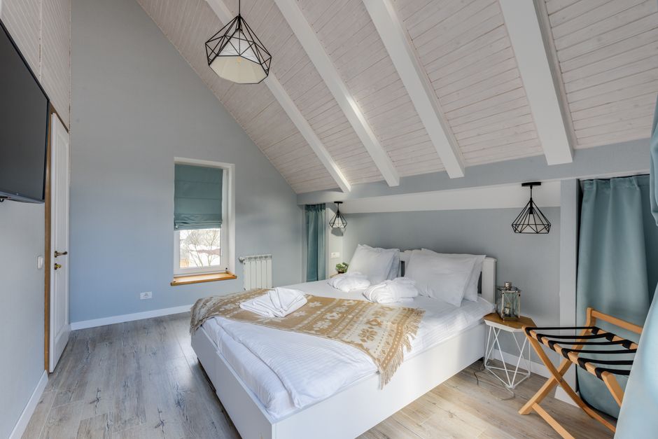 Bright and inviting minimalist bedroom with rustic decor elements and natural lighting.