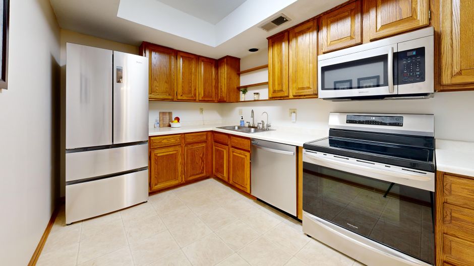Cozy kitchen with stainless steel appliances and wooden cabinetry.