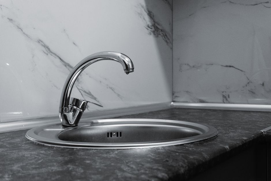 Sleek stainless steel sink and faucet in a contemporary kitchen setting.