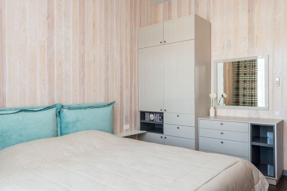 Contemporary bedroom featuring sleek furniture and soft teal accents.