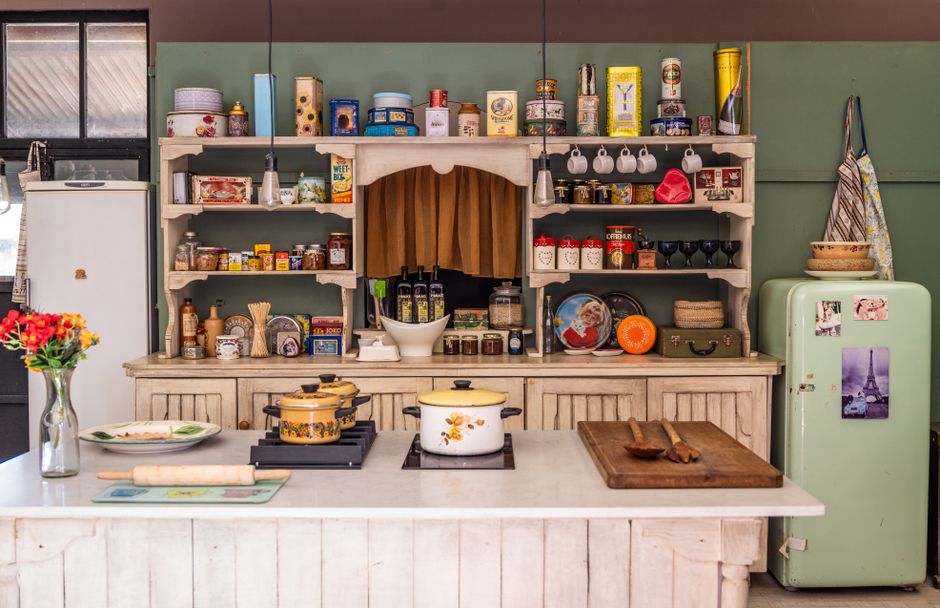 Charming vintage kitchen featuring retro appliances, utensils, and colorful decorations, creating a nostalgic ambiance.